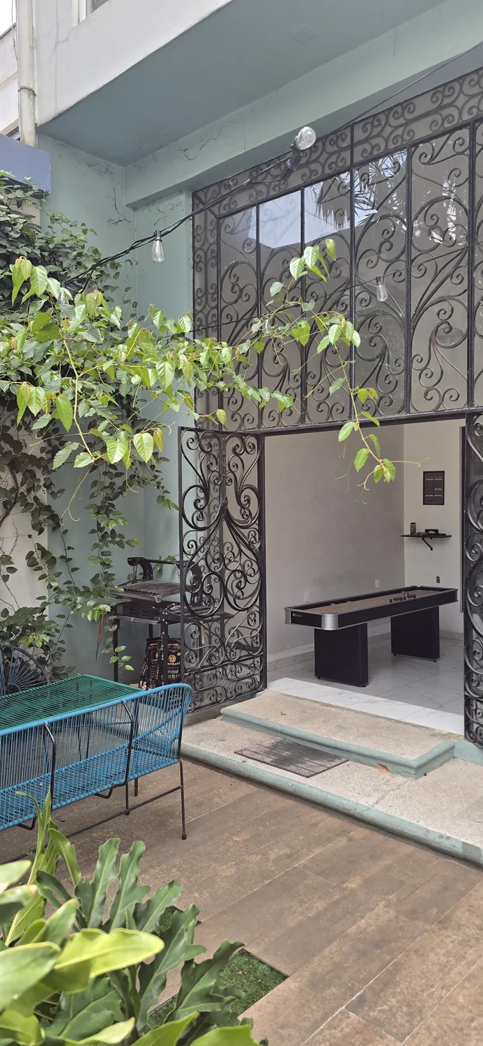 Leafy outdoor courtyard and shaded seating area.